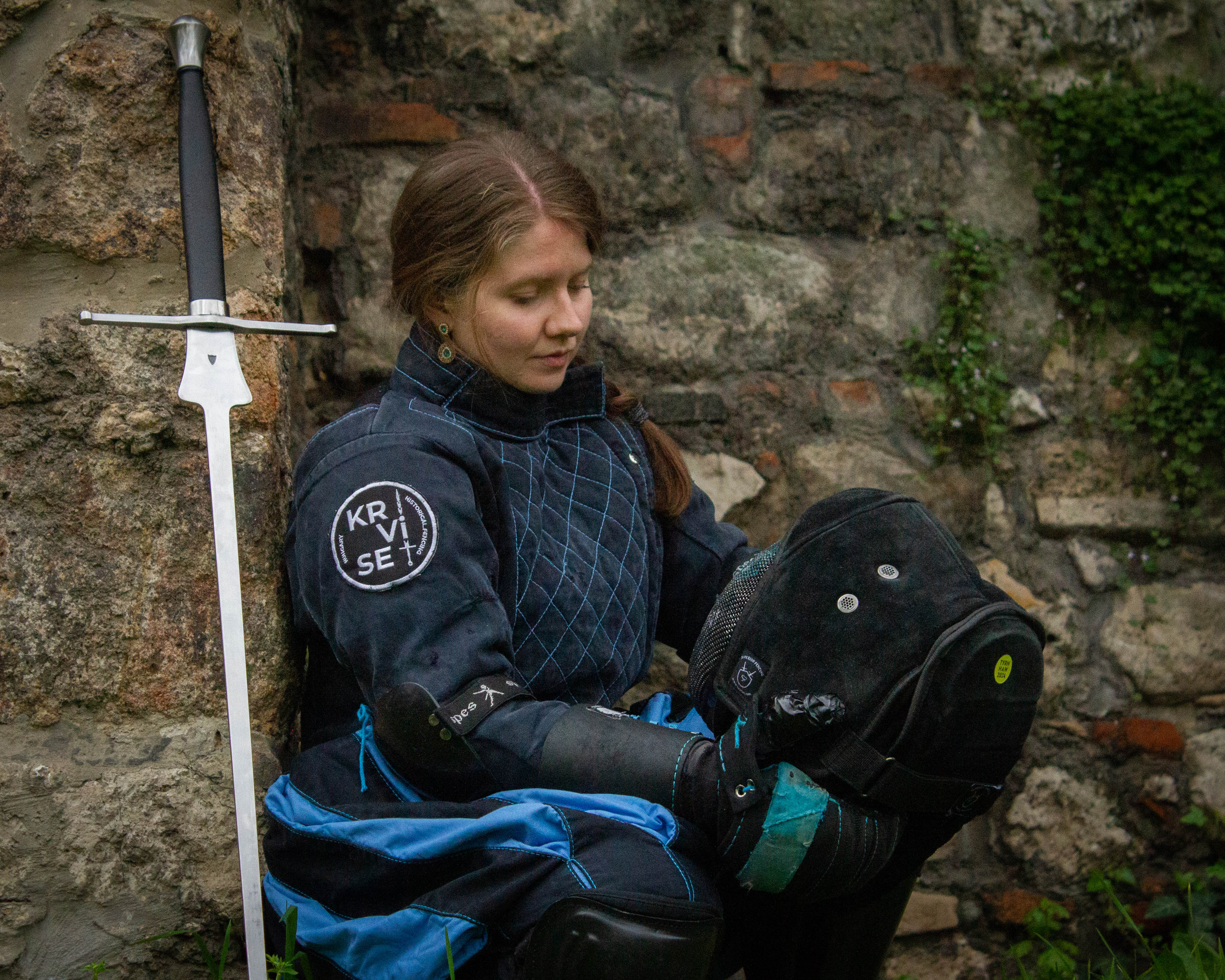 female fencer in gear with feder sword
